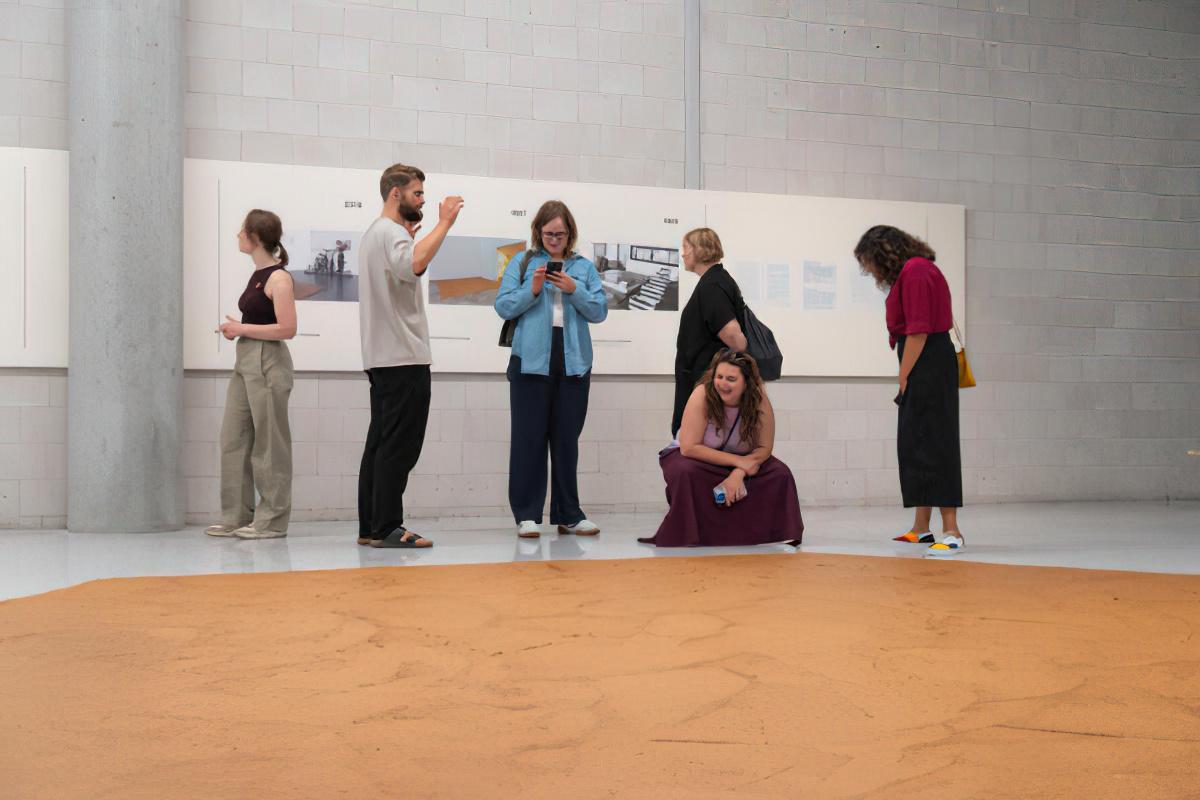 Museum visitors look at the Peanut Butter Floor artwork.